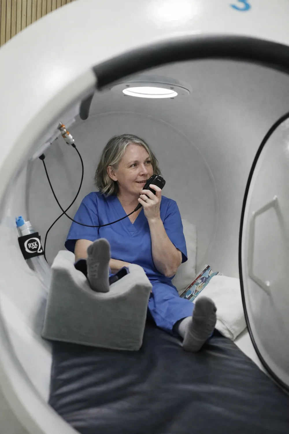 Patient holding the communication handset inside a hyperbaric chamber