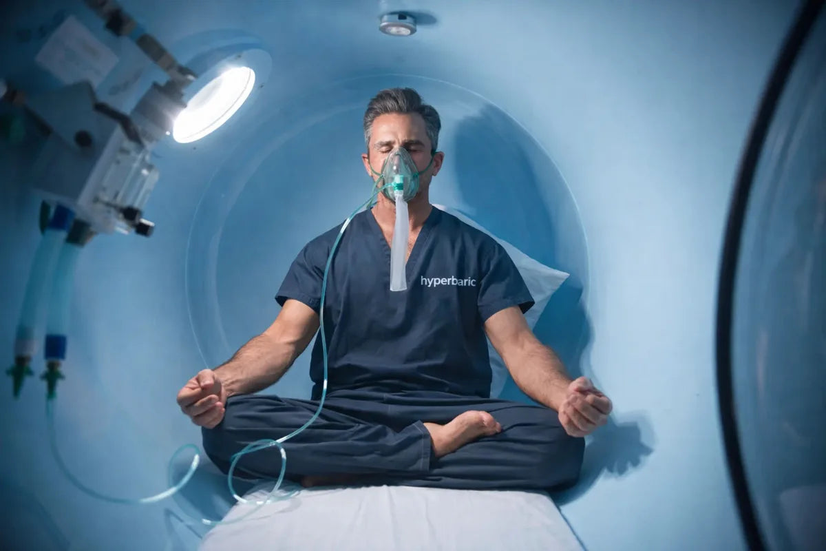 Person seated in a hyperbaric chamber using an oxygen mask