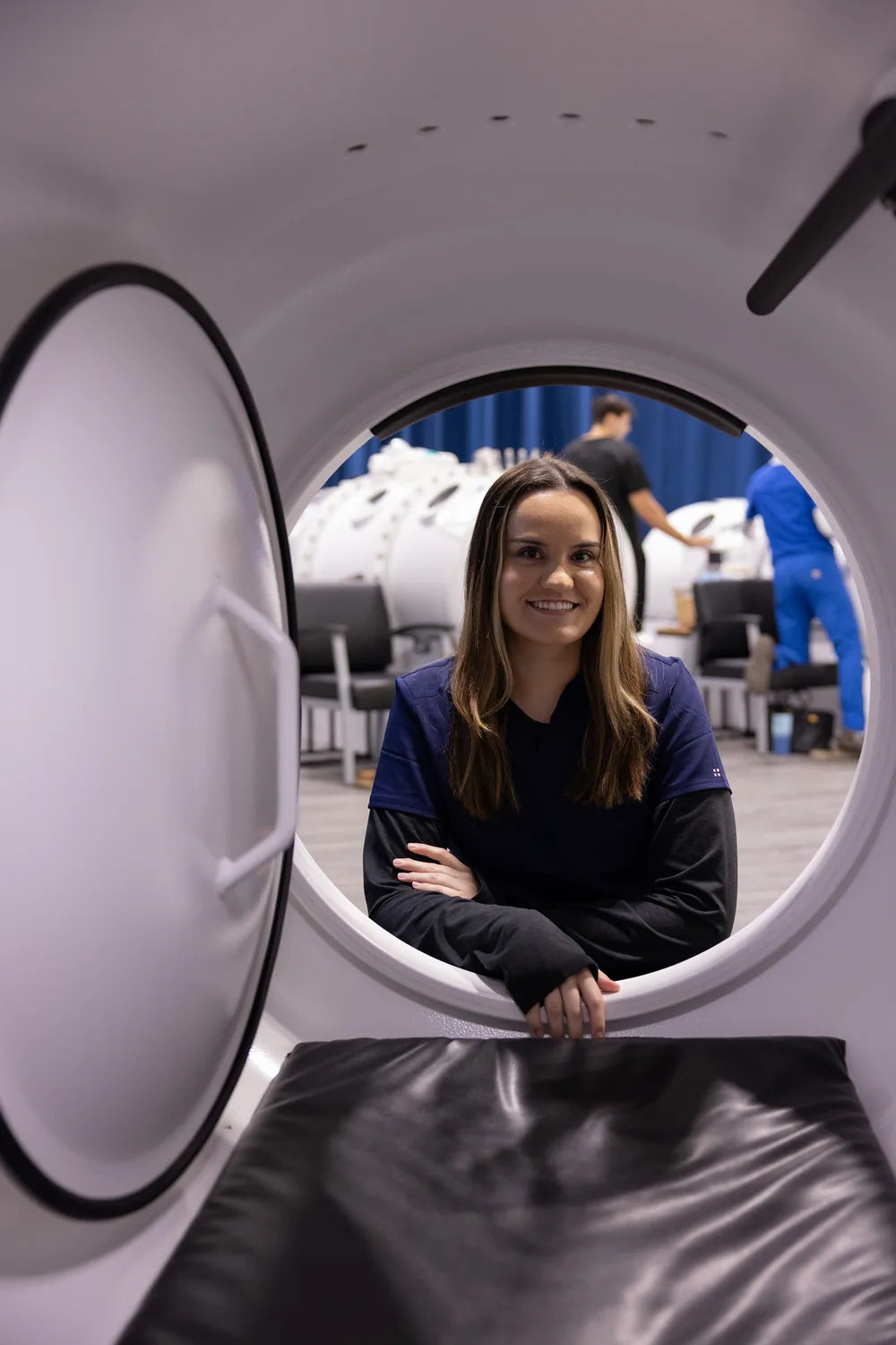 RX-O2 team member smiling through the open entrance of a hyperbaric chamber
